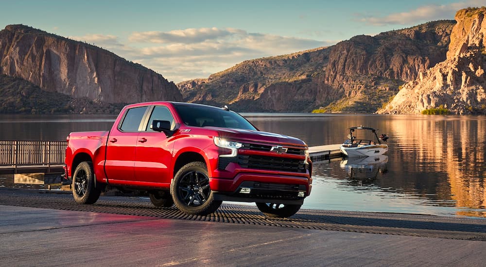 A red 2022 Chevy Silverado 1500 Z71 parked near water.