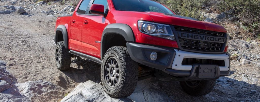 A red 2019 Chevy Colorado ZR2 Bison off-roading to a Devine Chevy dealer.