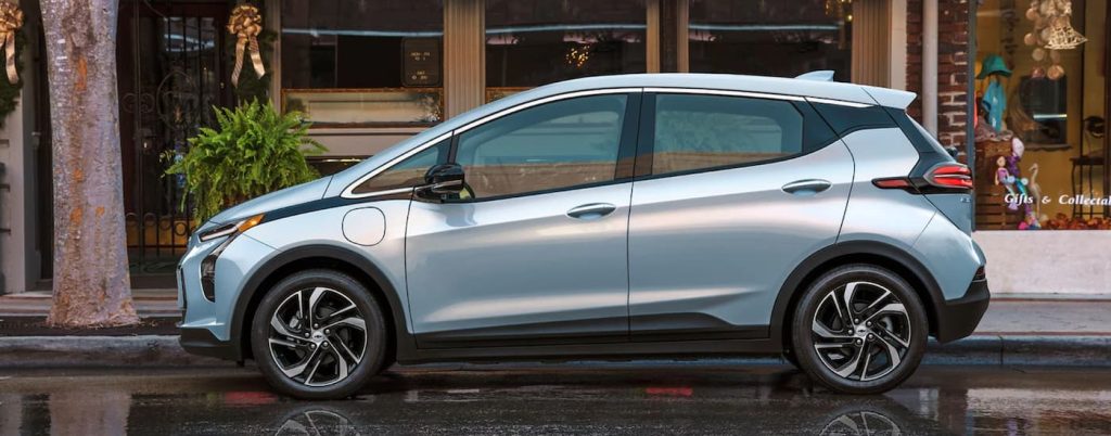 A blue 2022 Chevy Bolt EV parked in front of a store after leaving a Chevrolet dealership San Antonio.