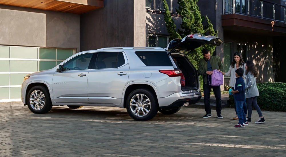 A silver 2022 Chevy Traverse on a driveway after visiting a Helotes Chevy dealer.