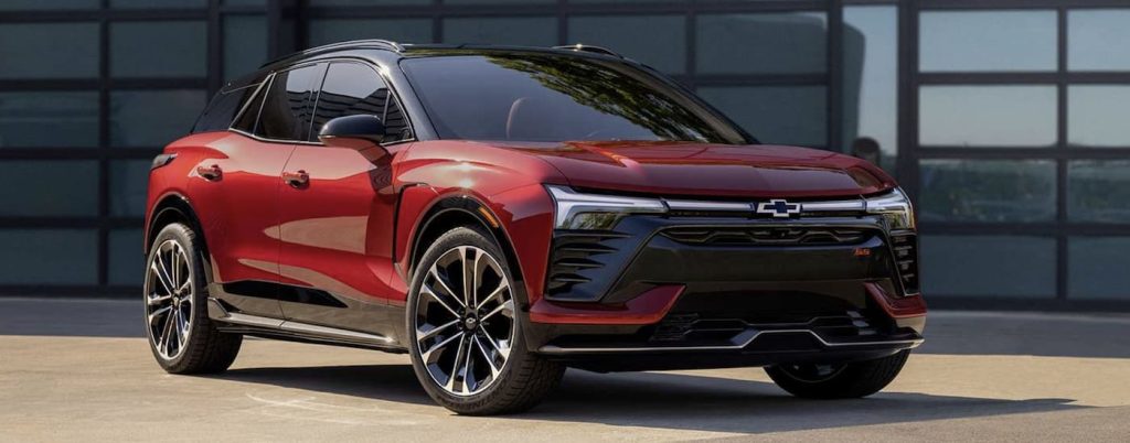 A red 2024 Chevy Blazer EV SS is shown from the front at a Chevy EV dealer.