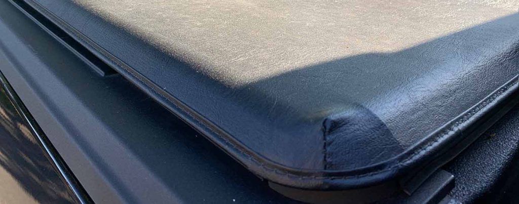 A black Tonneau Cover is shown at a used truck dealer near San Antonio.