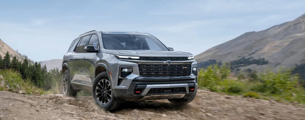 2025 Chevy Traverse driving over a dirt road.