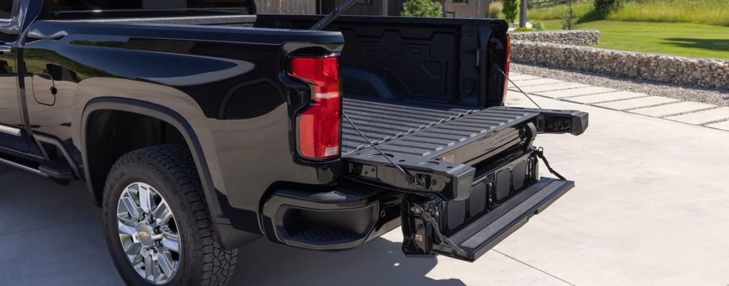 Open bed of a black Chevy Silverado 2500 HD.