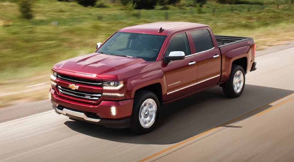 A red 2017 Chevy Silverado 1500 LTZ Z71 is shown from the side driving to a Certified Pre-Owned Chevy dealer.