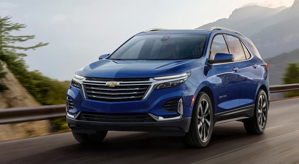 A blue 2022 Chevy Equinox is shown leaving a Oak Grove Chevrolet dealer.