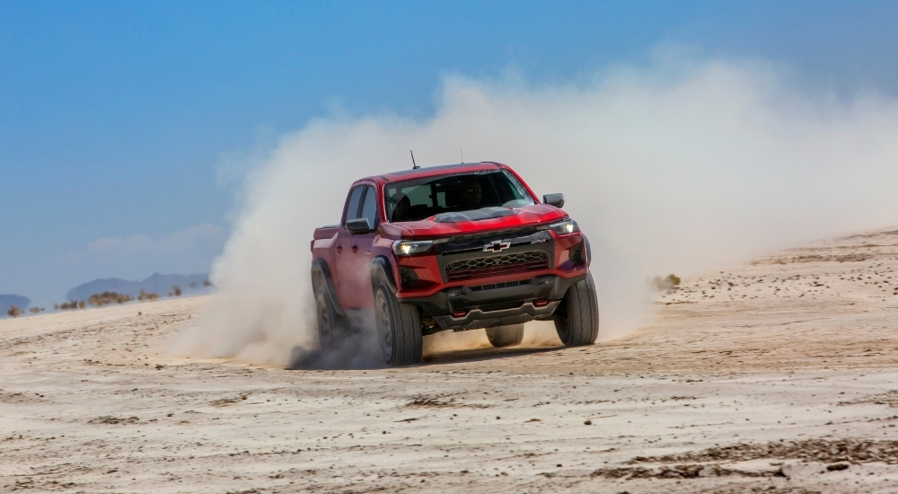 A red 2025 Chevy Colorado ZR2 driving off-road.