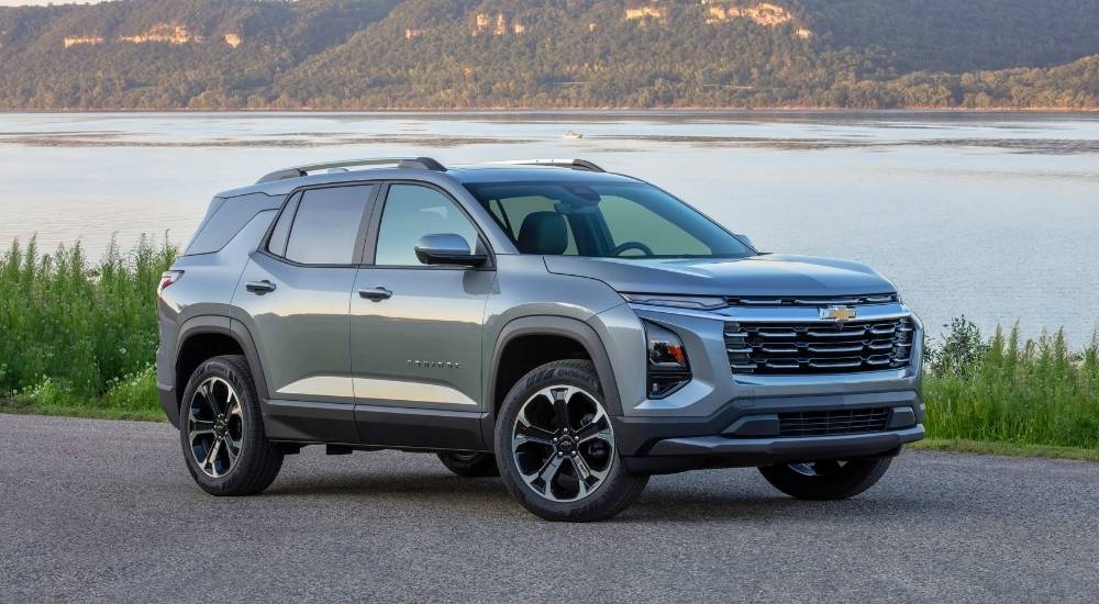 Grey 2025 Chevy Equinox LT parked in front of a lake
