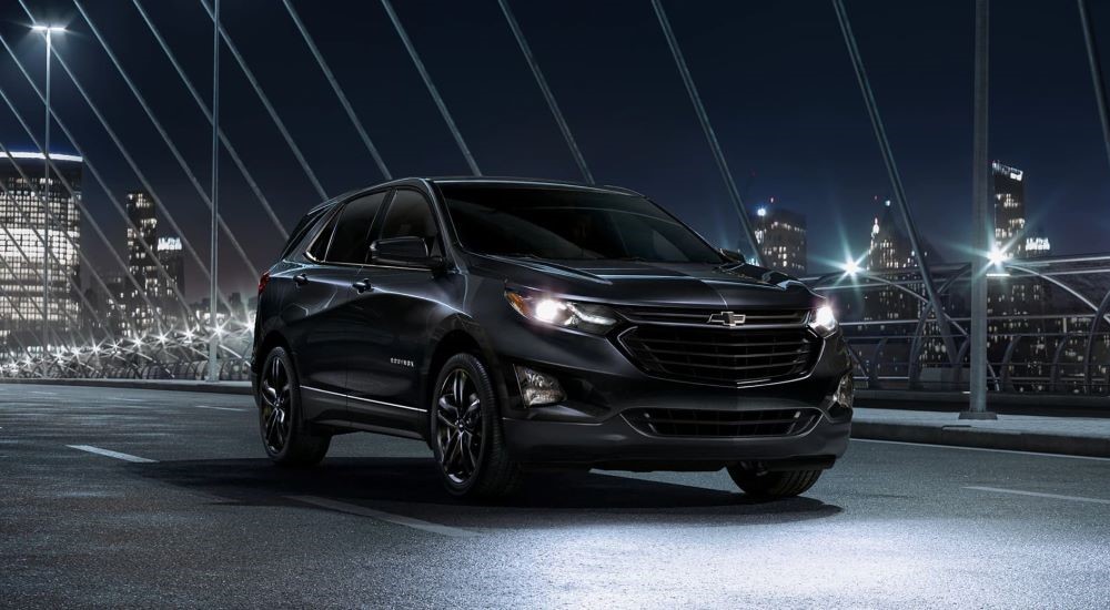 A black 2020 Chevy Equinox Midnight Edition driving to a used Chevy dealer.