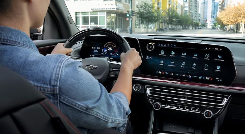A person driving in a 2025 Chevy Traverse.