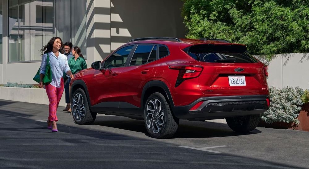 Red 2026 Chevy Trax RS parked on the side of a city street