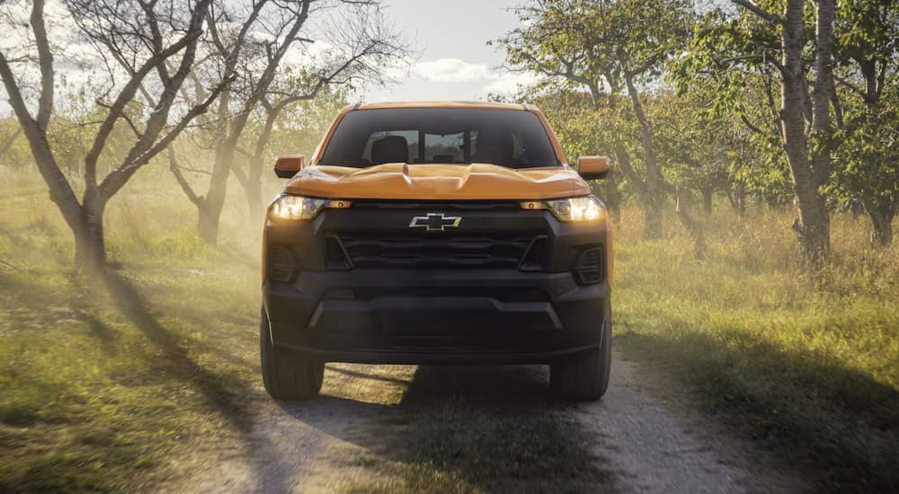 A yellow 2026 Chevy Colorado parked off-road on a trail