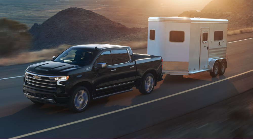 Black 2026 Chevy Silverado 1500 LD towing a trailer