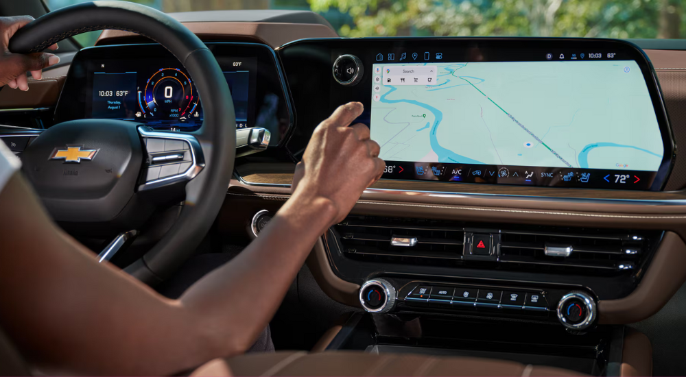 A person uses the infotainment system in a 2026 Chevy Tahoe