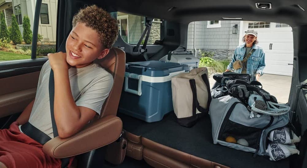 A child seated in the interior of a 2026 Chevy Tahoe.