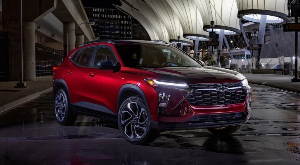 A red 2026 Chevy Trax RS parked at night.