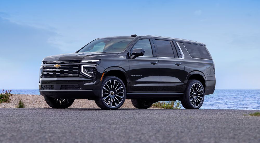 Black 2026 Chevy Suburban High Country on the beach.