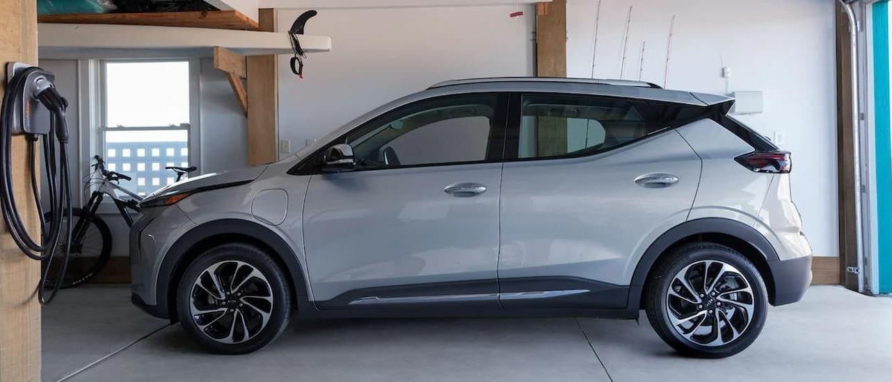 A silver 2022 Chevy Bolt EUV is shown from the side parked in a garage.