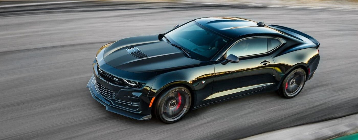 A black 2022 Chevy Camaro ZL1 1LE is driving on pavement.