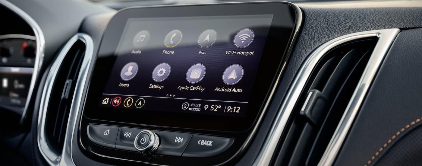 The black interior of a 2022 Chevy Equinox shows the infotainment screen.