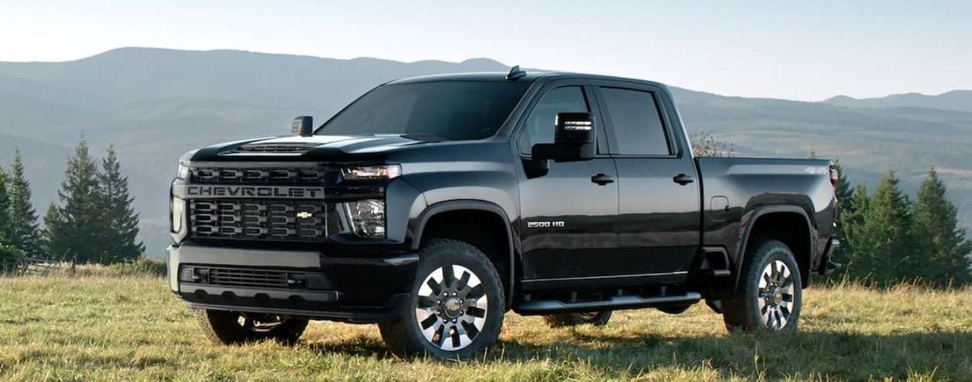 A black 2022 Chevy Silverado 2500 HD parked in a field.
