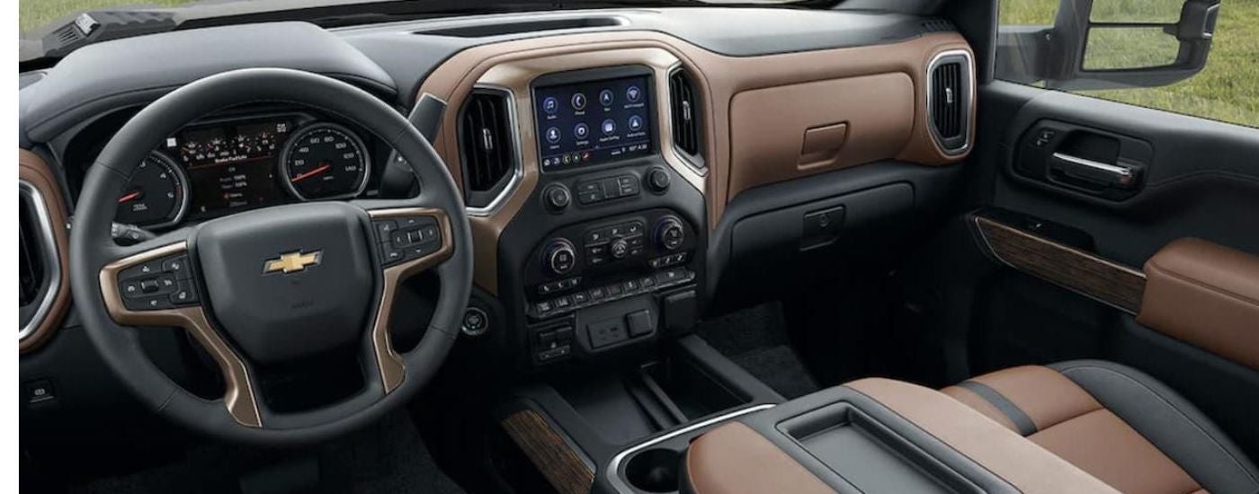 The brown and black interior of a 2022 Chevy Silverado 2500 HD.