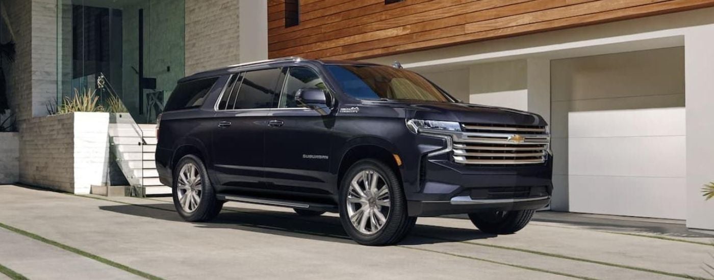 A blue 2022 Chevy Suburban parked on a driveway.