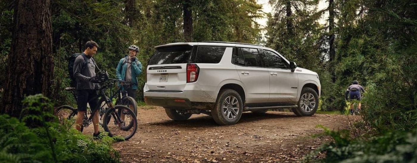 A white 2022 Chevy Tahoe parked in the woods.