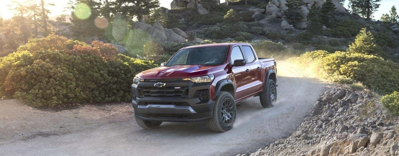 Red 2023 Chevy Colorado Trail Boss driving down a trail