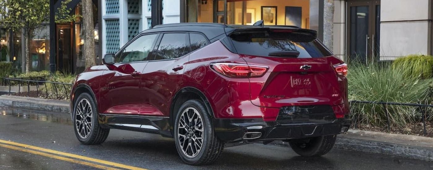 A red 2022 Chevy Blazer RS driving in a city.