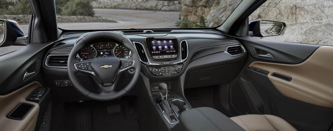 The black and brown interior of a 2023 Chevy Equinox.