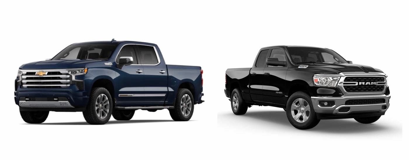 A blue 2023 Chevy Silverado 1500 High Country and black 2023 Ram 1500 facing opposite directions.