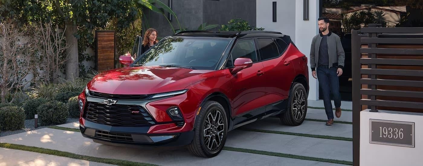 A red 2024 Chevy Blazer RS is shown parked in a driveway.
