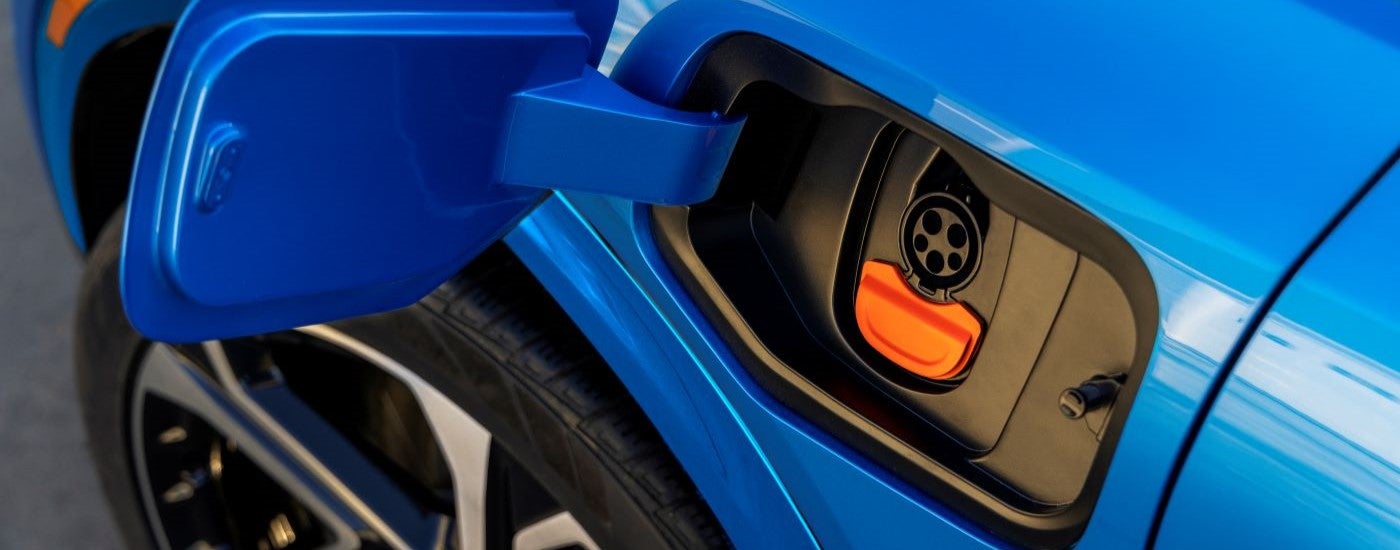 A close up of the charge port on a blue 2024 Chevy Equinox EV.