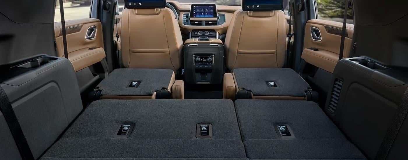 The folded seats and center console of a 2024 Chevy Suburban is shown.