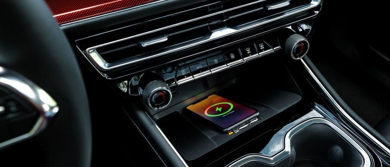 A phone is shown charging in a 2024 Chevy Traverse RS.