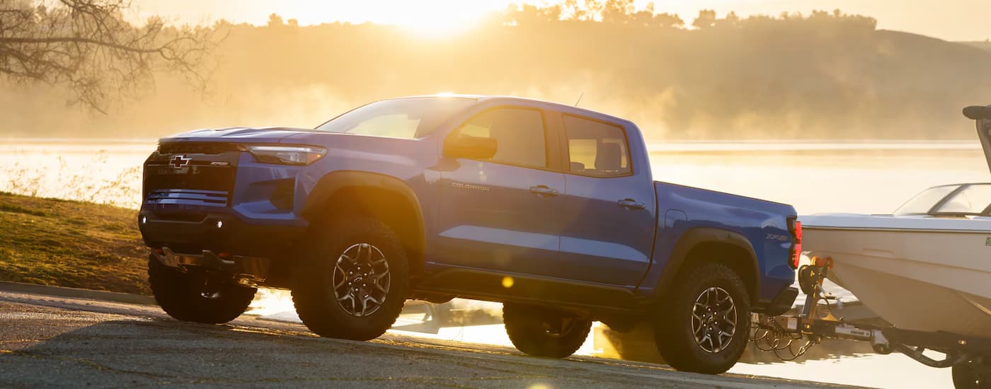 A blue 2026 Chevy Colorado towing a boat out of water