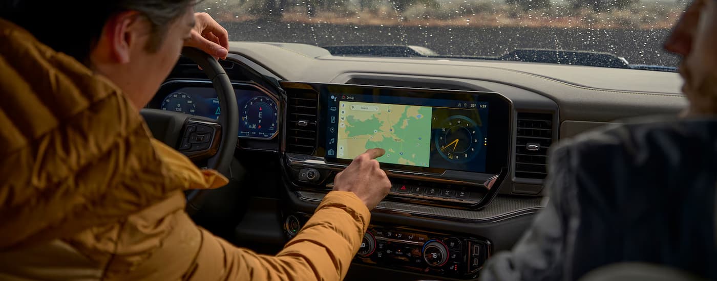 Two people using the map screen in a 2026 Chevy Silverado 1500