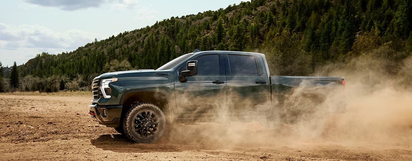 A green 2026 Chevy Silverado 2500 ZR2 off-roading.