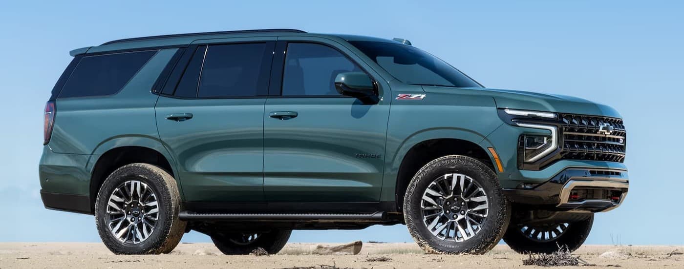 A green 2026 Chevy Tahoe parked off-road.