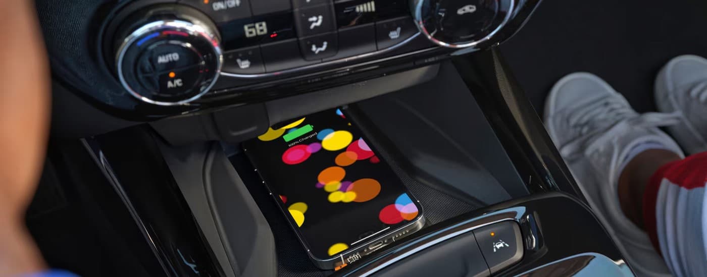 A cell phone charging in a 2026 Chevy Trax.