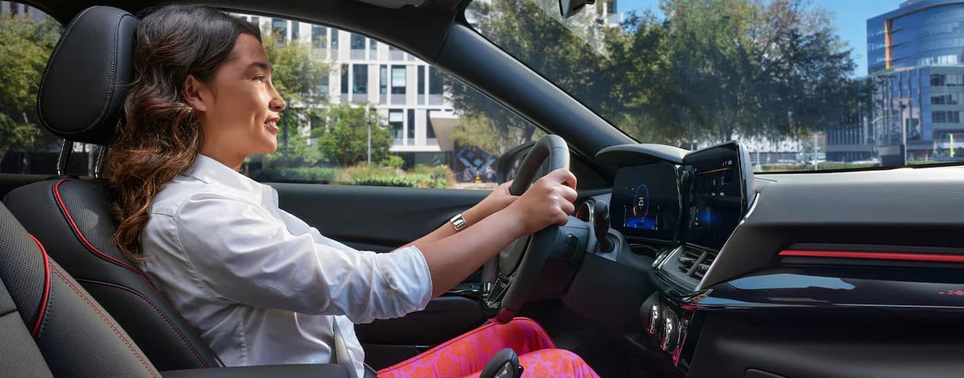 A person driving in a 2026 Chevy Trax.