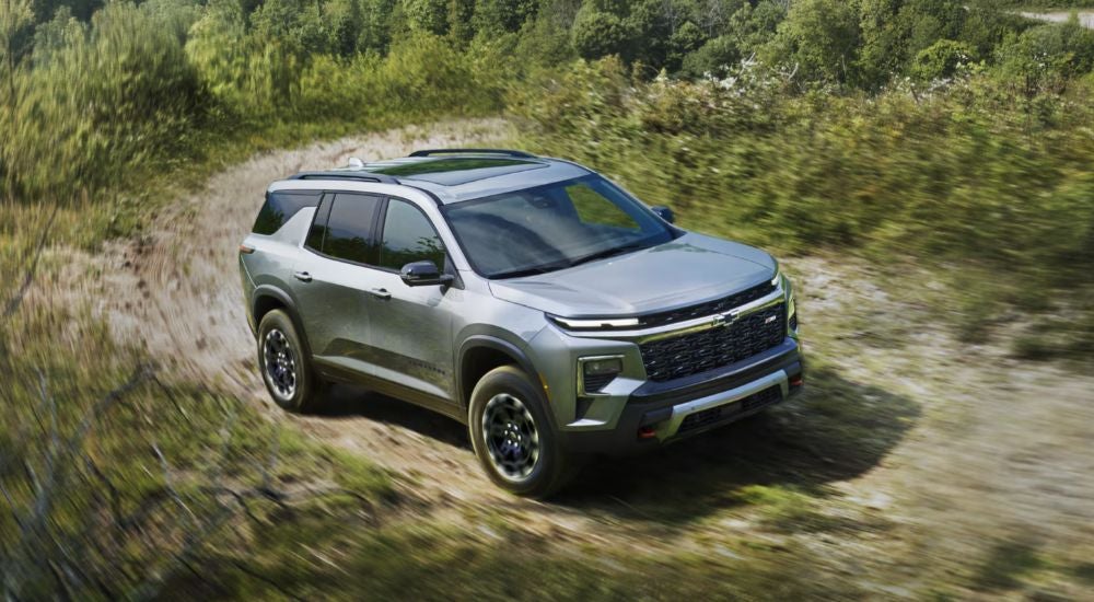 A silver 2027 Chevy Traverse Z71 driving off-road.