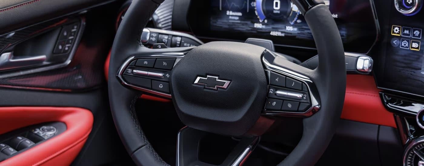 A black and red steering wheel in a 2025 Chevy Blazer EV RS.