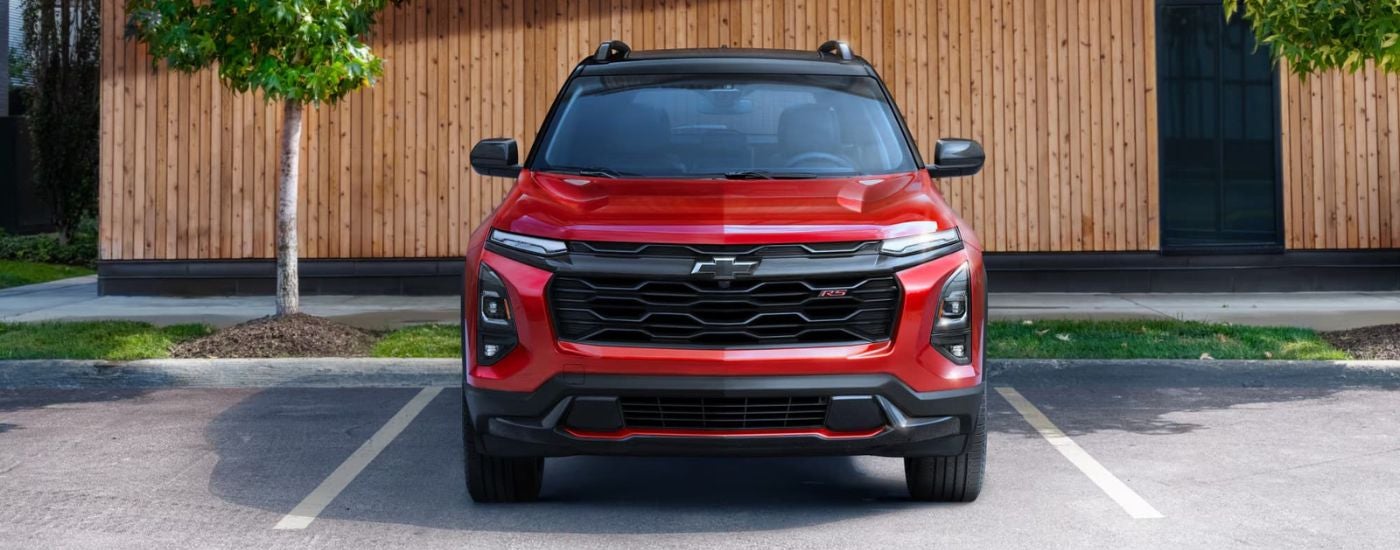 A red 2025 Chevy Equinox is parked on a parking space after leaving a Chevy dealer near you.