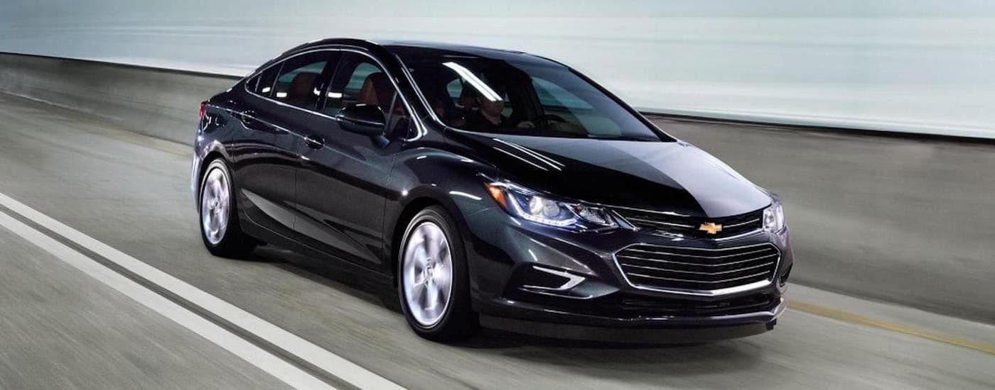 A black 2017 Chevy Cruze is shown driving through a tunnel.