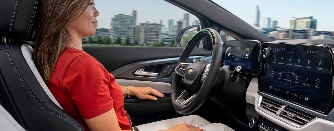 A woman is using the Super Cruise driving feature in a 2025 Chevy Equinox EV.