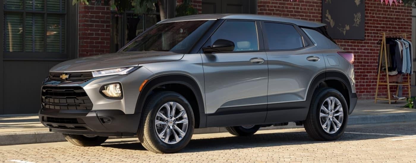 A grey 2023 Chevy Trailblazer is shown parked on the side of a city street.