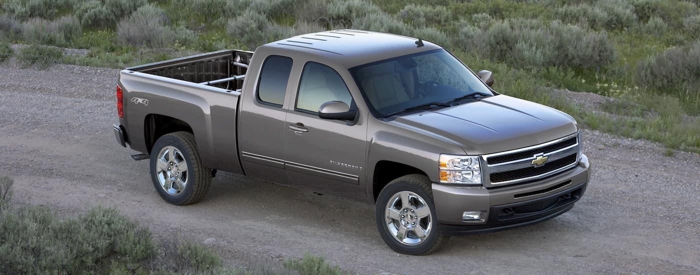 A grey 2009 Chevy Silverado 1500 parked near a Chevy Silverado 1500 dealer.