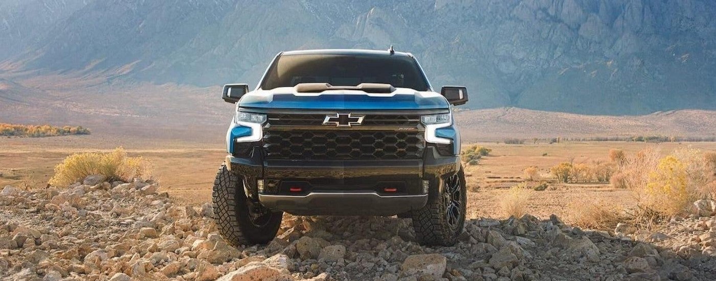 A blue 2024 Chevy Silverado ZR2 parked off-road.
